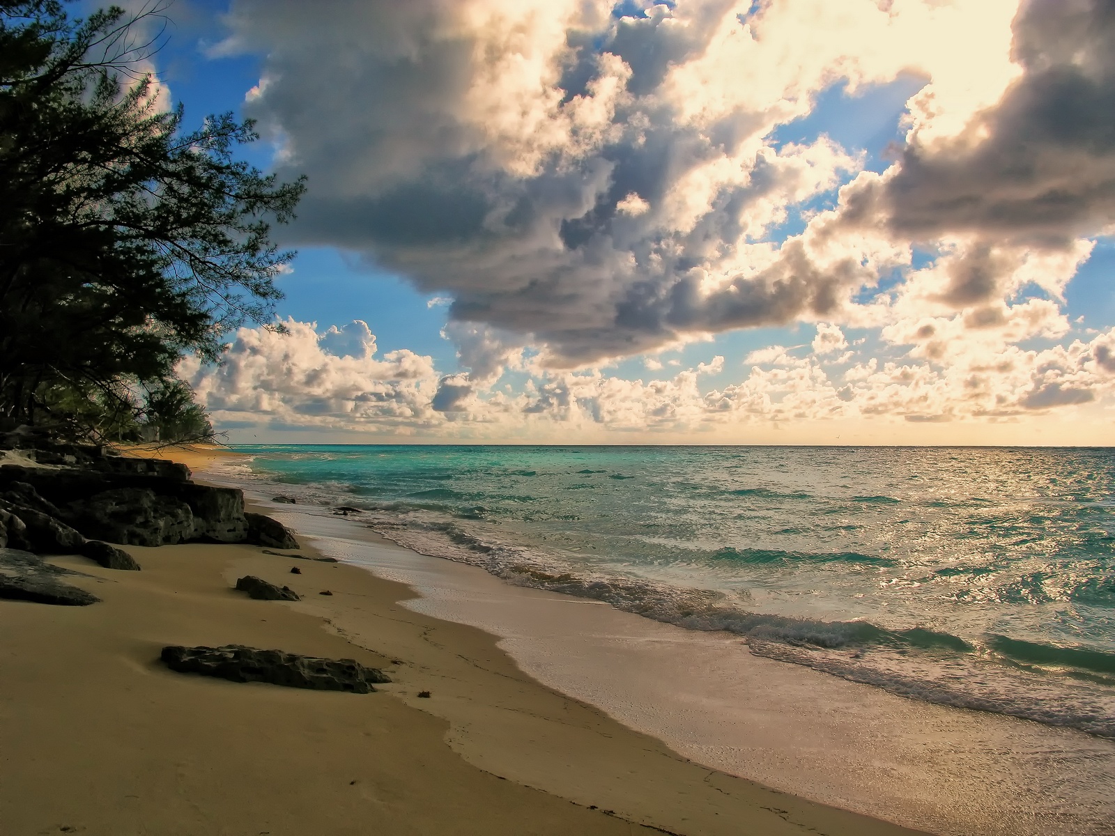 The Sun looks for openings as it moves down the beach.