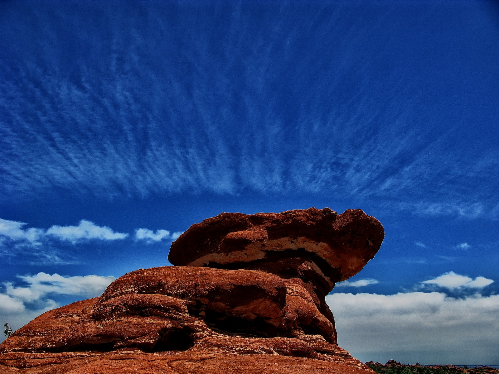A perfect cloud formation surrounds the Scotsman Rock.